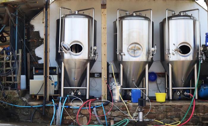 Three fermenters outside of the Brewery.